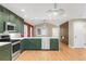 The well lit kitchen features an eat-in countertop, wood floors and flows into an adjoining living space at 306 E Iowa Ave, Berthoud, CO 80513