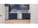Modern kitchen featuring stainless steel appliances and blue cabinets at 306 E Iowa Ave, Berthoud, CO 80513
