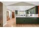 Remodeled open floor plan with view of coat rack, entryway, kitchen and barstool seating at 306 E Iowa Ave, Berthoud, CO 80513