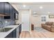 Nicely finished kitchenette features blue cabinets, sleek countertops, tile backsplash, and a stainless steel sink at 306 E Iowa Ave, Berthoud, CO 80513