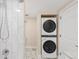 Efficient laundry area with stacked washer and dryer unit, and bright lighting at 306 E Iowa Ave, Berthoud, CO 80513