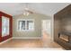 Open living room features hardwood floors, modern fireplace, and bright windows at 306 E Iowa Ave, Berthoud, CO 80513