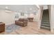 Spacious living room with a piano and stairs at 306 E Iowa Ave, Berthoud, CO 80513