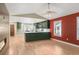 Open living space featuring vaulted ceilings, fireplace, green accent walls and a large window with an eat-in area at 306 E Iowa Ave, Berthoud, CO 80513