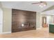 Modern living space with wood paneled accent wall featuring fireplace and mantle with plenty of natural light at 306 E Iowa Ave, Berthoud, CO 80513