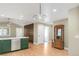 Open-concept living space adjacent to kitchen, featuring modern light fixtures and built-in fireplace at 306 E Iowa Ave, Berthoud, CO 80513