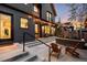 Outdoor living space with concrete patio, lounge seating, string lights, and beautiful home exterior at 1035 S Josephine St, Denver, CO 80209