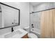 Contemporary bathroom featuring a shower and tub combination, neutral tiles, and sleek fixtures at 1035 S Josephine St, Denver, CO 80209