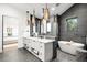 Elegant bathroom featuring a soaking tub, double vanity, and stunning tiled accent wall at 1035 S Josephine St, Denver, CO 80209