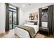 Cozy bedroom with a large window, stylish decor, and hardwood floors at 1035 S Josephine St, Denver, CO 80209