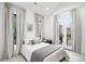 Bright bedroom with large windows and doors providing access to an outdoor space at 1035 S Josephine St, Denver, CO 80209