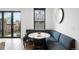 Cozy breakfast nook with booth seating, circular table, and outdoor view at 1035 S Josephine St, Denver, CO 80209