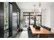 Dining room with wood table, gray chairs, and pendant lighting near large window at 1035 S Josephine St, Denver, CO 80209