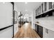 Bright hallway featuring hardwood floors, wine fridge, and modern staircase at 1035 S Josephine St, Denver, CO 80209