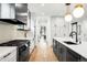 Modern kitchen with stainless steel appliances, island, and hardwood floors at 1035 S Josephine St, Denver, CO 80209