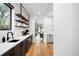 Modern kitchen with wood floors, marble countertops, and stainless steel appliances at 1035 S Josephine St, Denver, CO 80209