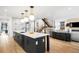 Modern kitchen boasts a large island with white countertops, pendant lighting, and wood floors at 1035 S Josephine St, Denver, CO 80209