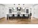Large kitchen island with barstool seating, modern lighting, and hardwood flooring at 1035 S Josephine St, Denver, CO 80209