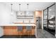 Modern kitchen boasting a large island, stainless steel appliances, and open shelving at 1035 S Josephine St, Denver, CO 80209