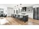 Large kitchen island with barstool seating, modern lighting, and hardwood flooring at 1035 S Josephine St, Denver, CO 80209