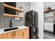 Functional laundry room featuring modern washer and dryer, storage, and patterned wall at 1035 S Josephine St, Denver, CO 80209