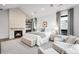 Bright main bedroom featuring a brick fireplace, natural light, and a sitting area at 1035 S Josephine St, Denver, CO 80209