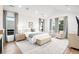 Bright and airy main bedroom with large windows, neutral tones, and a cozy sitting area at 1035 S Josephine St, Denver, CO 80209