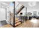 Modern staircase with wood treads and metal railings, connecting the home's open living spaces at 1035 S Josephine St, Denver, CO 80209