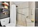 Updated bathroom with a tiled shower, built-in seat, and modern fixtures at 8371 S Upham Way # 208, Littleton, CO 80128