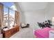 Bright bedroom with a large window, neutral carpet, and cozy furniture at 8371 S Upham Way # 208, Littleton, CO 80128