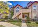 Inviting condo with a quaint red door and stairs leading to an upper-level entrance at 8371 S Upham Way # 208, Littleton, CO 80128