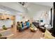 Open-concept living room with vaulted ceilings, wood floors, and stylish decor at 8371 S Upham Way # 208, Littleton, CO 80128
