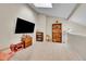 Spacious living room with neutral carpet, built-in shelving, and ample natural light at 8371 S Upham Way # 208, Littleton, CO 80128