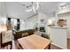 Open-concept living room with modern lighting and a cozy fireplace at 8371 S Upham Way # 208, Littleton, CO 80128