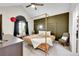 Stylish main bedroom with a four-poster bed, vaulted ceiling, and dark accent wall at 8371 S Upham Way # 208, Littleton, CO 80128