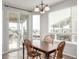 Bright dining area features a wood table, deck access, and abundant natural light from large windows at 1335 Galactic Pl, Castle Rock, CO 80108