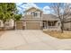 Charming two-story home featuring a three-car garage and covered porch, framed by mature trees and a lush lawn at 1335 Galactic Pl, Castle Rock, CO 80108