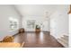Bright living room features gleaming hardwood floors, large windows offering ample natural light, and neutral paint at 1335 Galactic Pl, Castle Rock, CO 80108