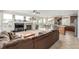 Open-concept layout combines living room with fireplace, media center, plush seating, kitchen, and dining area at 1335 Galactic Pl, Castle Rock, CO 80108