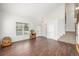 Bright living room features gleaming hardwood floors, large windows offering ample natural light, and neutral paint at 1335 Galactic Pl, Castle Rock, CO 80108