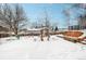 Snowy backyard with trees and landscaping at 13390 W 8Th Ave, Lakewood, CO 80401