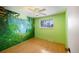 Bedroom with jungle mural and wood flooring at 13390 W 8Th Ave, Lakewood, CO 80401