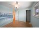 Bedroom with wood floors, mural, and ceiling fan at 13390 W 8Th Ave, Lakewood, CO 80401