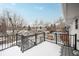 Back deck with metal railing overlooks a snowy backyard at 13390 W 8Th Ave, Lakewood, CO 80401