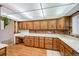 Kitchen with extensive wood cabinetry and a brick backsplash at 13390 W 8Th Ave, Lakewood, CO 80401