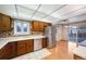 Kitchen with wood cabinets, stainless steel appliances, and brick backsplash at 13390 W 8Th Ave, Lakewood, CO 80401