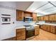 Kitchen with wood cabinets, stainless steel appliances, and brick accent wall at 13390 W 8Th Ave, Lakewood, CO 80401