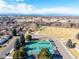 Scenic aerial view showcasing recreational facilities, a green park area, and the distant mountain range at 8335 Fairmount Dr # 4-102, Denver, CO 80247