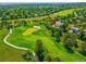 Scenic aerial view of the home with golf course views; highlighted with a red arrow at 7332 Woodglen Pl, Castle Pines, CO 80108