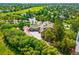 Secluded home surrounded by mature trees, featuring a well-maintained driveway and golf course views at 7332 Woodglen Pl, Castle Pines, CO 80108